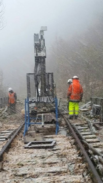 Homme sur chantier ligne ferroviaire travaillant sous la neige